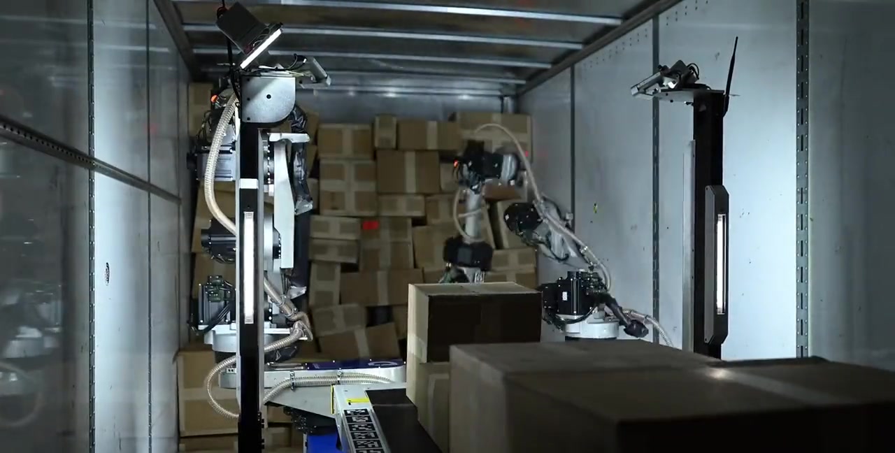 Mech dual-arm robot actively loading boxes into a truck